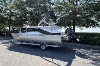 Slide: The Image of 2020 SunCatcher V20 Fish & Cruise pontoon boat on trailer, parked outdoors. - 6