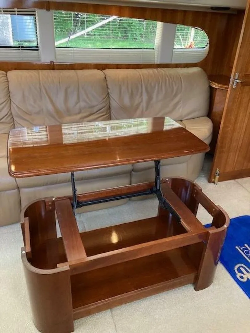 Slide: The Image of Interior of 2003 Carver 396 Aft Cabin MY with wooden table and leather sofa. - 15