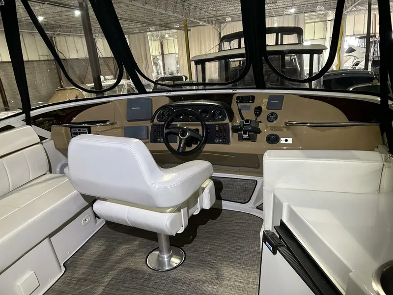 Slide: The Image of 2003 Carver 396 Aft Cabin MY helm with white seating and modern controls. - 23