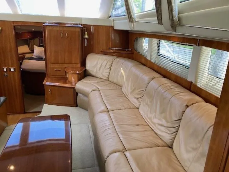 Slide: The Image of Luxurious interior of 2003 Carver 396 Aft Cabin MY with leather seating and wood accents. - 10