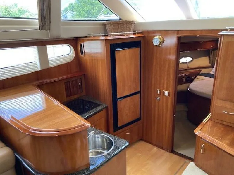 Slide: The Image of Interior of 2003 Carver 396 Aft Cabin MY yacht with wood finish and kitchenette. - 7