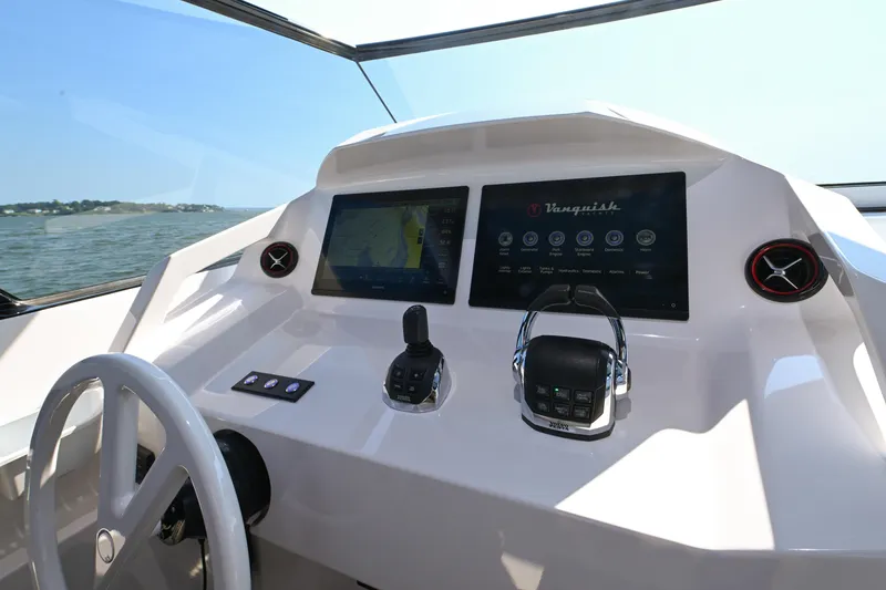 Slide: The Image of Helm of 2022 Vanquish VQ58 yacht with modern controls and navigation screens. - 10