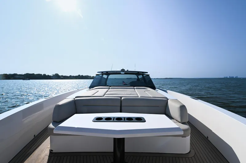 Slide: The Image of 2022 Vanquish VQ58 luxury yacht on open water, featuring sleek design and spacious deck. - 14