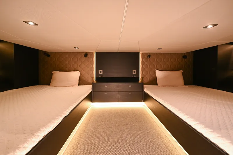 Slide: The Image of Luxurious 2022 Vanquish VQ58 yacht cabin with twin beds and ambient lighting. - 22