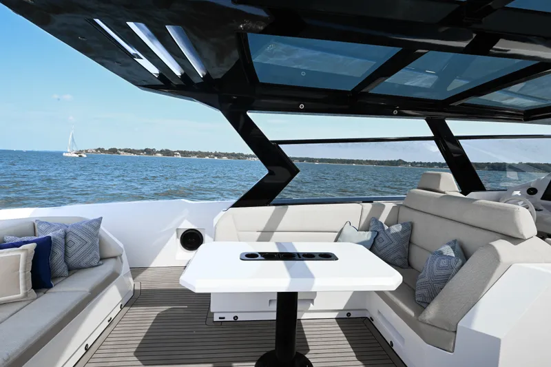 Slide: The Image of Luxurious 2022 Vanquish VQ58 yacht interior with elegant seating and ocean view. - 8