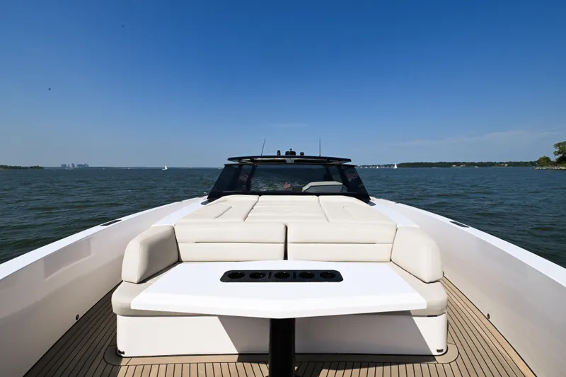 Slide: The Image of Luxury 2022 Vanquish VQ58 yacht with spacious deck and seating on open water. - 13