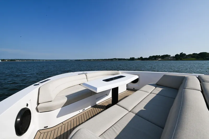 Slide: The Image of Luxurious 2022 Vanquish VQ58 yacht with elegant seating on a serene lake. - 15