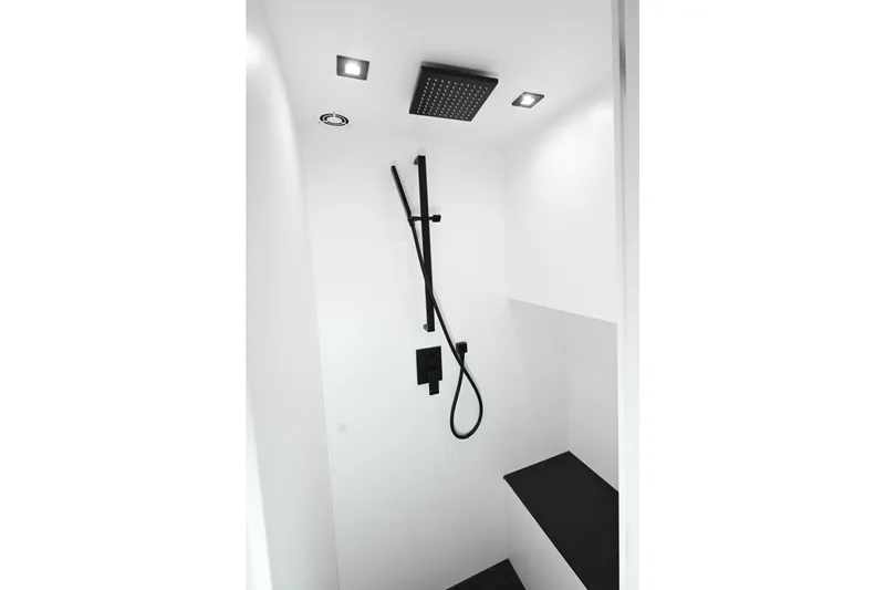 Slide: The Image of Modern shower in 2022 Vanquish VQ58 yacht, featuring sleek black fixtures and minimalist design. - 19