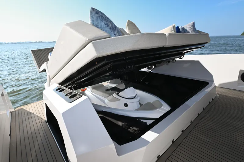 Slide: The Image of 2022 Vanquish VQ58 yacht with open storage compartment, revealing a jet ski. - 26