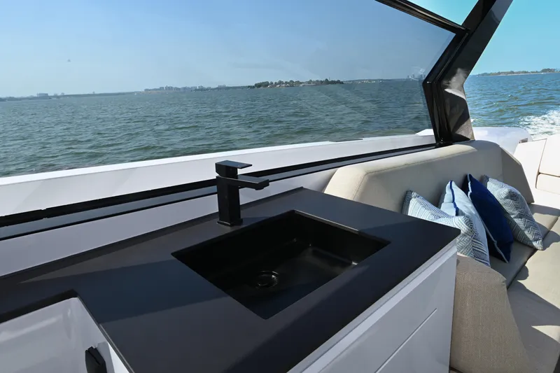 Slide: The Image of Luxury Vanquish VQ58 yacht interior with sleek sink and comfortable seating, 2022 model. - 27