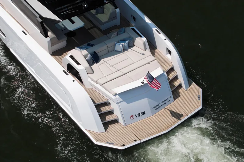Slide: The Image of Luxury Vanquish VQ58 yacht, 2022 model, cruising with elegant deck seating and American flag. - 5