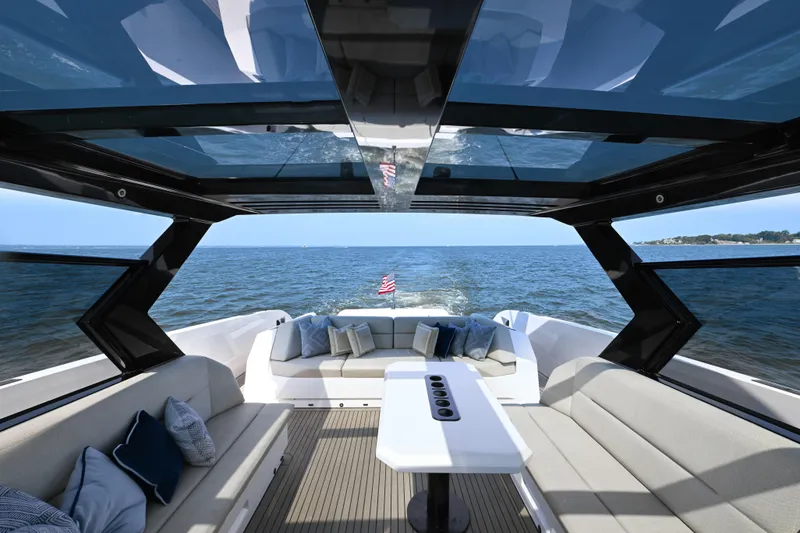 Slide: The Image of Luxurious 2022 Vanquish VQ58 yacht interior with ocean view and elegant seating. - 7