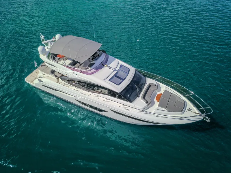 Slide: The Image of 2018 Princess S60 yacht cruising on clear blue water, aerial view. - 23