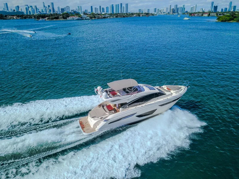 Slide: The Image of 2018 Princess S60 yacht cruising on blue waters with city skyline in background. - 24