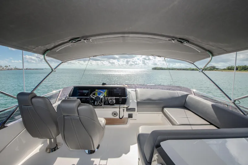 Slide: The Image of 2018 Princess S60 yacht cockpit with ocean view, featuring modern seating and navigation controls. - 5