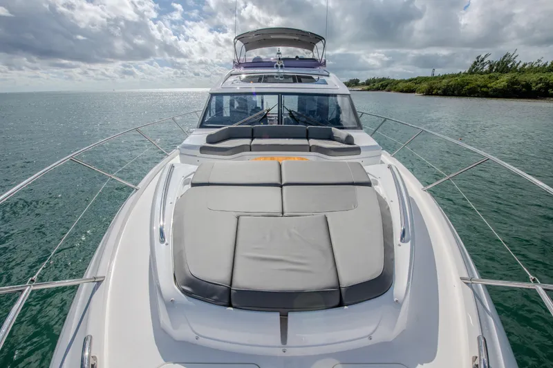 Slide: The Image of 2018 Princess S60 yacht with spacious deck, cruising on calm waters under a cloudy sky. - 7