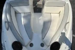 Slide: The Image of 2011 Bayliner 185 Bowrider boat interior with white seating and speakers. - 5