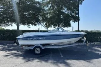 Slide: The Image of 2011 Bayliner 185 Bowrider on trailer in sunny parking lot. - 6