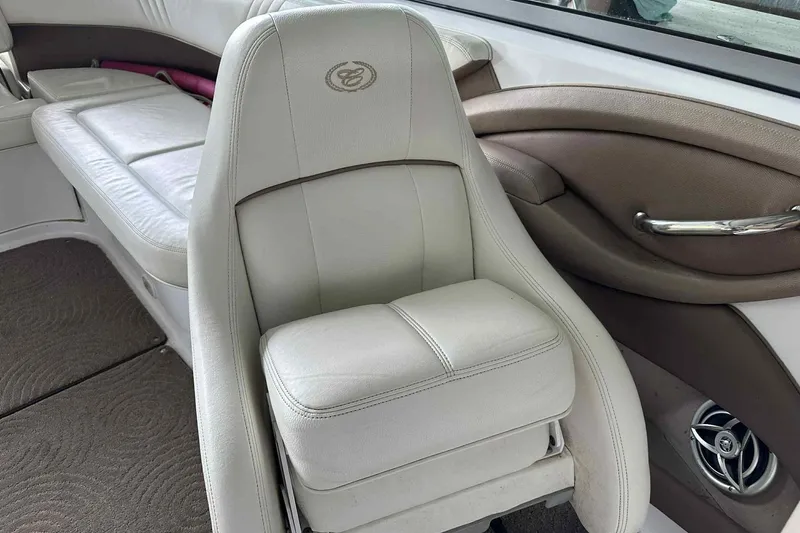 Slide: The Image of 2008 Cobalt 252 boat interior with white leather seating and stylish design. - 11