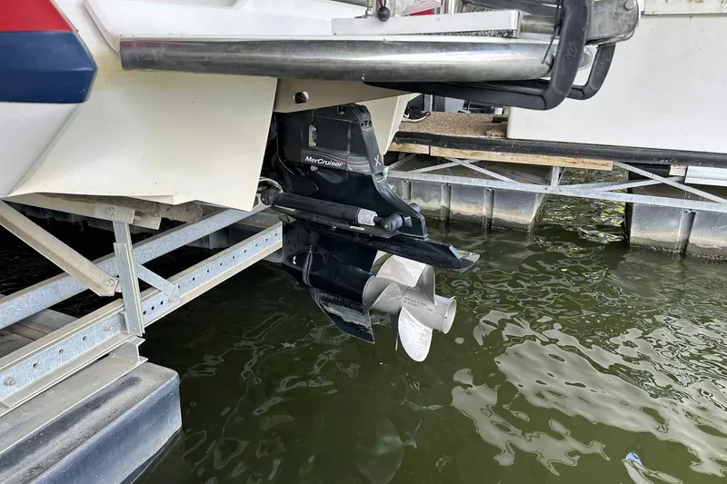 Slide: The Image of 2008 Cobalt 252 boat with MerCruiser outdrive, docked near water. - 19