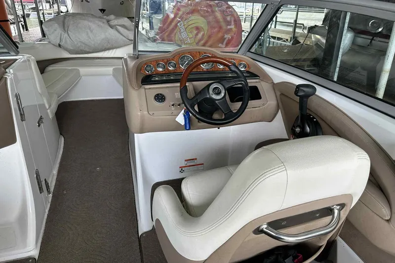 Slide: The Image of Interior of a 2008 Cobalt 252 boat featuring steering wheel and dashboard controls. - 22
