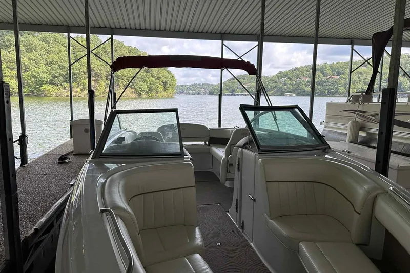 Slide: The Image of 2008 Cobalt 252 boat docked, featuring spacious seating and scenic lake view. - 23