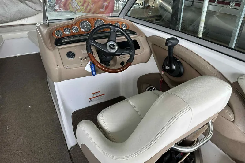 Slide: The Image of 2008 Cobalt 252 boat interior with steering wheel and control panel. - 24