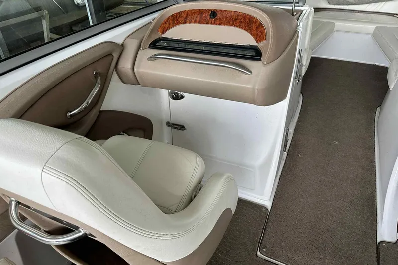 Slide: The Image of Interior of a 2008 Cobalt 252 boat with beige seating and carpet. - 27