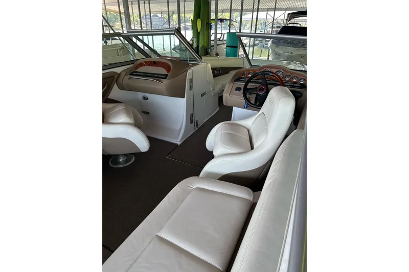 Slide: The Image of Interior of a 2008 Cobalt 252 boat with white leather seating and dashboard. - 30