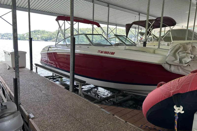 Slide: The Image of Red 2008 Cobalt 252 boat docked under a covered marina on a sunny day. - 8