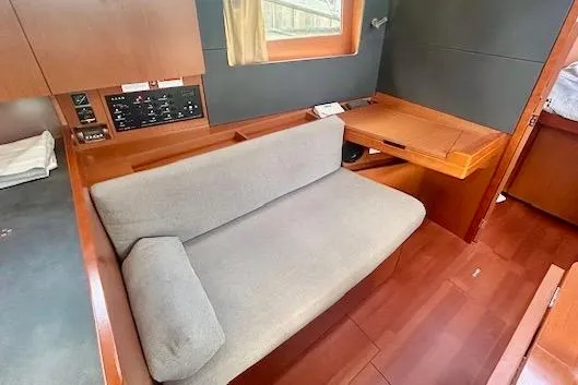 Slide: The Image of 2017 Beneteau Oceanis 41.1 interior with sofa and wooden furnishings. - 11