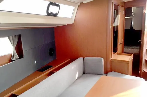 Slide: The Image of Interior of 2017 Beneteau Oceanis 41.1 yacht with modern wood finish and seating area. - 12