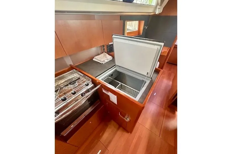 Slide: The Image of 2017 Beneteau Oceanis 41.1 yacht kitchen with open fridge and stove. - 15