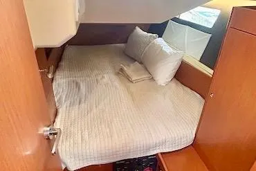 Slide: The Image of Cozy cabin interior of 2017 Beneteau Oceanis 41.1 sailboat with bed and wooden furnishings. - 18