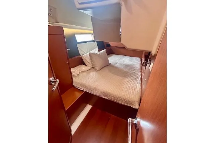 Slide: The Image of 2017 Beneteau Oceanis 41.1 cabin interior with cozy bed and wooden finish. - 19