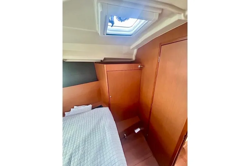 Slide: The Image of 2017 Beneteau Oceanis 41.1 cabin interior with bed and wooden paneling. - 20