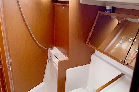 Slide: The Image of 2017 Beneteau Oceanis 41.1 yacht bathroom with wooden finish and modern fixtures. - 22