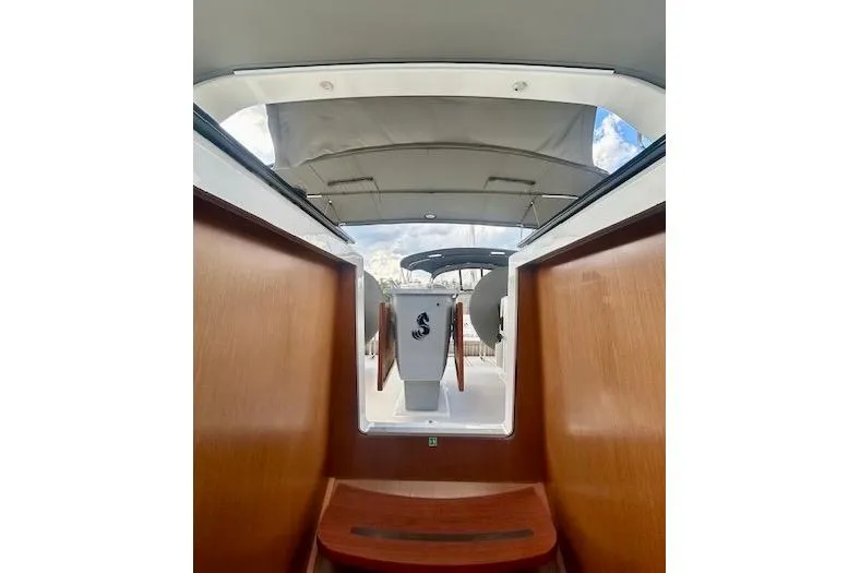 Slide: The Image of 2017 Beneteau Oceanis 41.1 yacht interior with wooden finish and open hatch view. - 23
