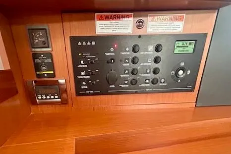 Slide: The Image of Control panel of a 2017 Beneteau Oceanis 41.1 sailboat, featuring various switches and indicators. - 25