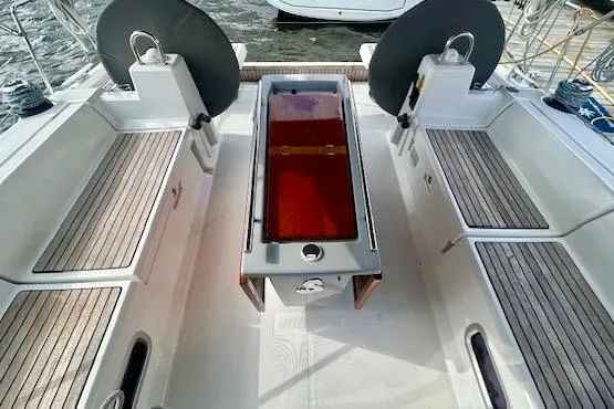 Slide: The Image of Cockpit of 2017 Beneteau Oceanis 41.1 sailboat with wooden seating and central table. - 5