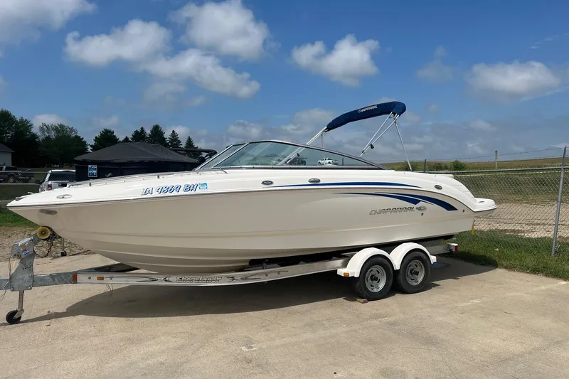The Image of 2009 Chaparral 236 SSi boat on trailer, parked outdoors under blue sky. - 1