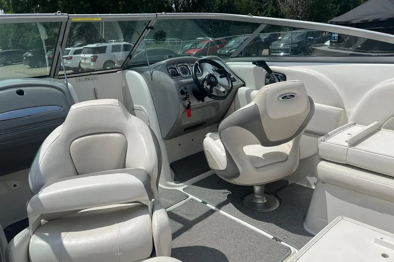 Slide: The Image of 2009 Chaparral 236 SSi boat interior with white seating and steering wheel. - 3