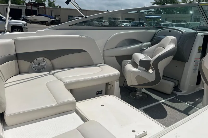 Slide: The Image of 2009 Chaparral 236 SSi boat interior with white seating and steering console. - 4