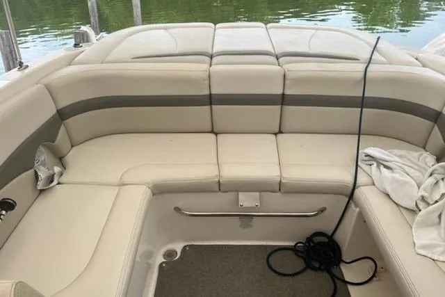 Slide: The Image of 2009 Chaparral 236 SSi boat interior with beige seating and lake view. - 5