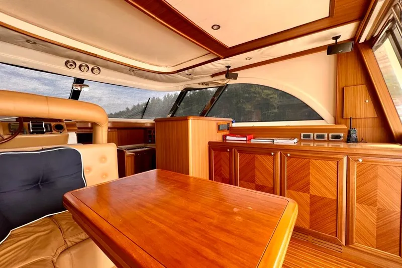 Slide: The Image of Luxurious interior of 2006 Mochi Craft 51 Dolphin yacht with elegant wood finishes. - 13