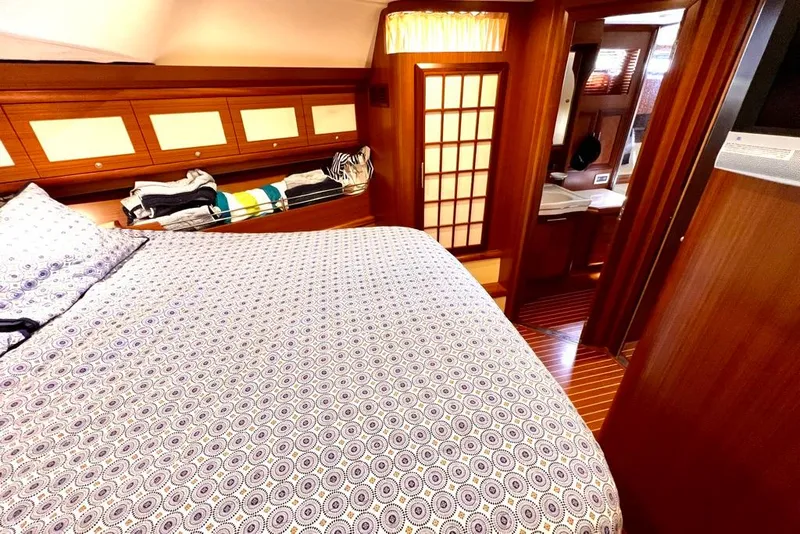 Slide: The Image of Luxurious cabin interior of 2006 Mochi Craft 51 Dolphin yacht with patterned bedding. - 17