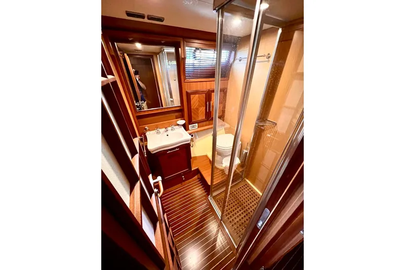 Slide: The Image of Luxurious bathroom in 2006 Mochi Craft 51 Dolphin yacht with wood accents and glass shower. - 19