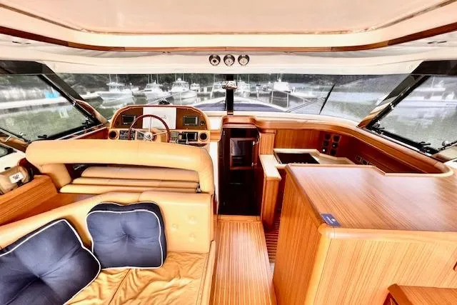 Slide: The Image of Interior of 2006 Mochi Craft 51 Dolphin yacht with luxurious wood finish and plush seating. - 9