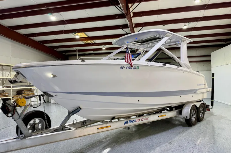 Slide: The Image of 2021 Chaparral 280 OSX boat on trailer in indoor storage facility. - 11