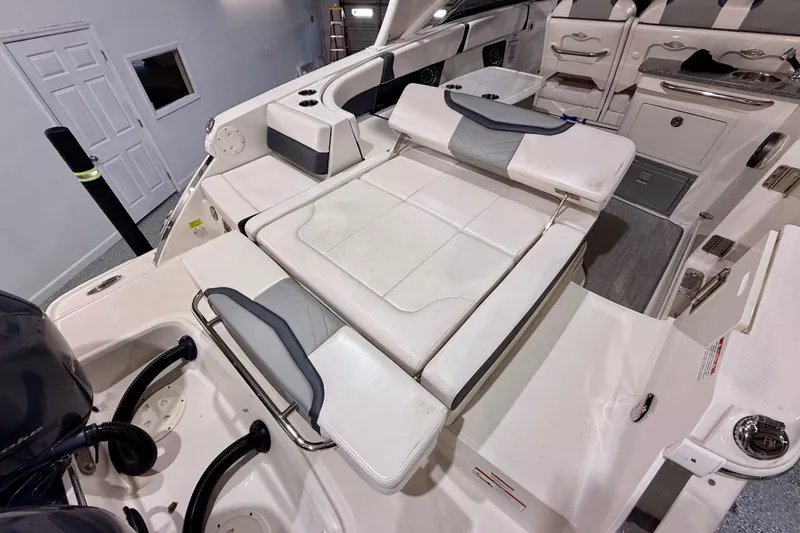 Slide: The Image of 2021 Chaparral 280 OSX boat interior with white seating and modern design. - 16